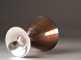a silver cup sitting on a table with a silver lid