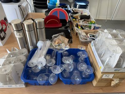 a table full of plastic cups and containers on it