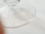 a glass of water sitting on a plate on a table
