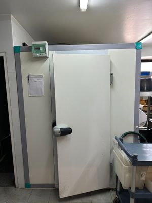an image of a room with a refrigerator and a table