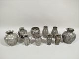 a lot of vases that are sitting on a table