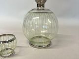 a glass vase and a glass bowl sitting on a table
