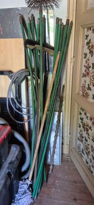 a pile of bamboo sticks and other items in a room