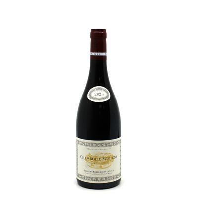 a bottle of red wine sitting on top of a white table