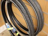 three tires that are on a rack in a store