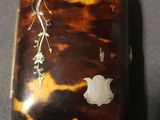 a tortoise shell case with a design on it