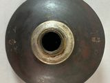 a metal vase with a hole in the middle of it