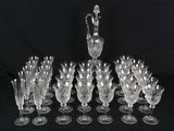 a lot of wine glasses and a pitcher on the table