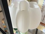 a lamp that is on a glass shelf in a room