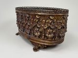 a metal bowl with carvings on it on a white surface
