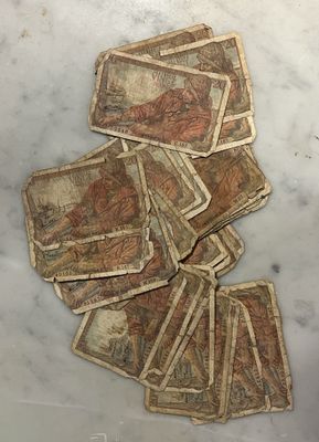 a pile of old money sitting on a marble table