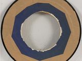 a blue and tan circular object on a white wall