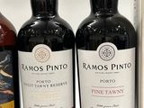 three bottles of wine sit on a shelf in front of a white background