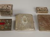 four different types of silver and gold jewelry on a white surface