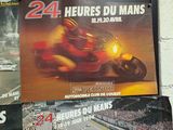 many posters on the wall of a race track