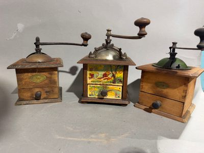 three different types of coffee grinders sitting on a table