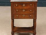 a small wooden table with a marble top on it