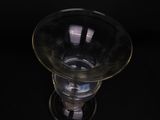 a glass vase that is sitting on a black table