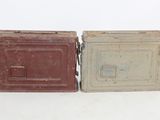 pair of old tin cans with lids and handles