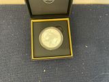 the coin is in a black box on the blue carpet