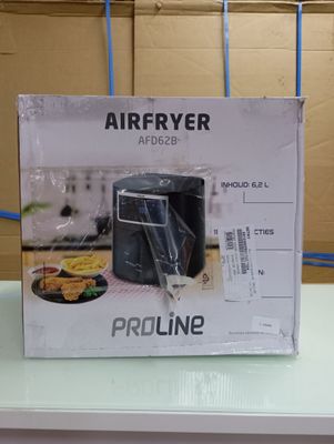 packaging of a black air fryer sitting on top of a white counter