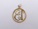 a gold plated pendant with the letter b in a circle