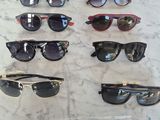 several pairs of sunglasses are on a table with a price tag