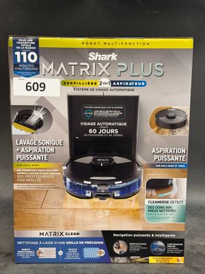 the box of the shark matrix plus vacuum cleaner is on the table