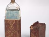 a bottle and a book sitting next to each other on a table