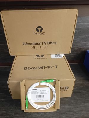 deux boîtes contenant des appareils électroniques posées l'une à côté de l'autre sur une table