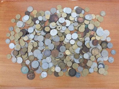 a pile of coins sitting on a wooden table