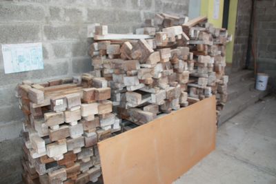 a pile of wood sitting next to a pile of bricks