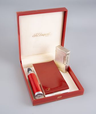 a red box with a pen, notebook and lighter in it