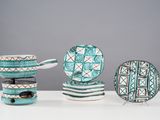 a white table topped with plates and bowls and spoons
