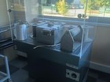 a machine that is sitting in a room with a checkered floor