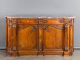 an old wooden sideboard with marble top