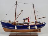 a model of a boat on a stand on a white surface