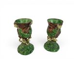 pair of green vases with birds on them on a white background