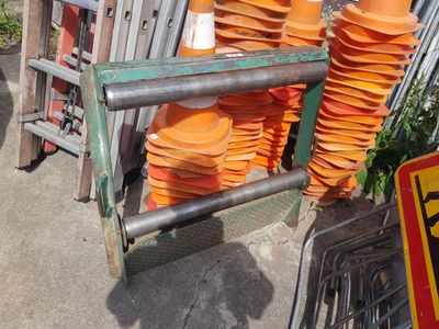 a pile of orange cones sitting on top of a metal rack