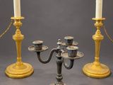 three candles are sitting on a table with a chain around them