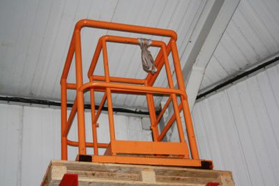 a man standing on a lift in a building