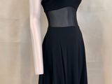 a mannequin wearing a black dress on a mannequin stand