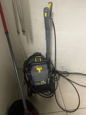 a vacuum and a mop on the floor next to a bucket