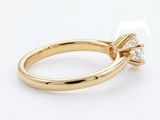 a close up of a diamond ring on a white surface