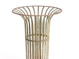 a metal basket that is sitting on a white surface