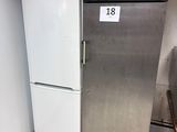 a silver refrigerator and a white refrigerator in a kitchen