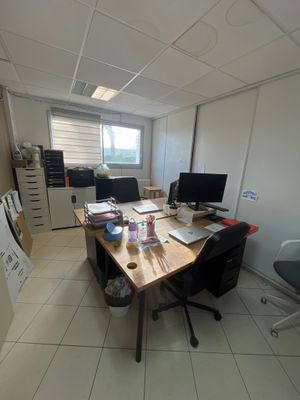 une photo d'une pièce avec un bureau et deux écrans