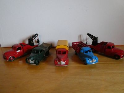 several toy cars are lined up in a row on a wooden table