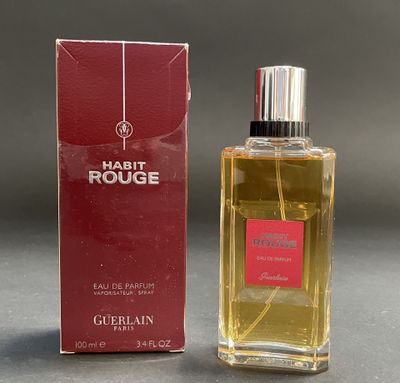 the bottle of the perfume is next to the box on the table