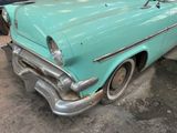 an old car that is sitting in the garage